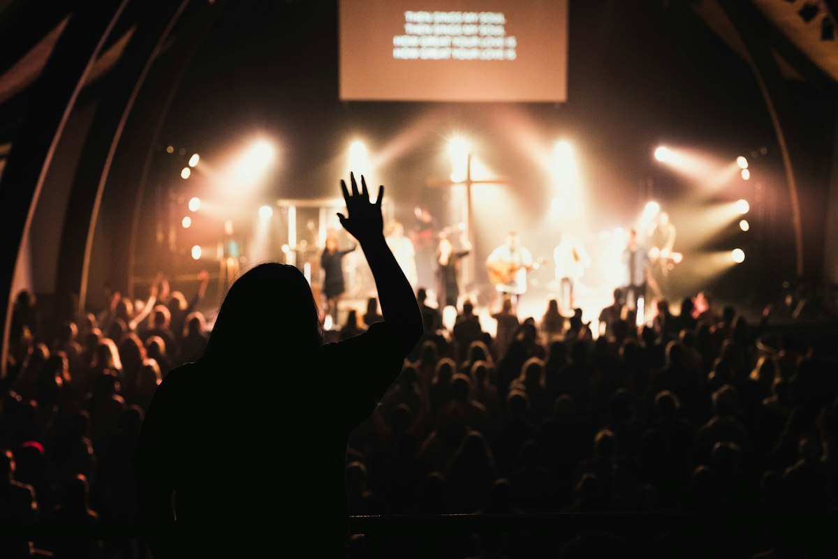 Congregation in worship with hands raised